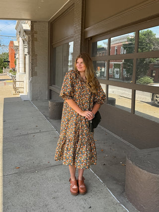 Woman wearing brown floral high neck midi dress