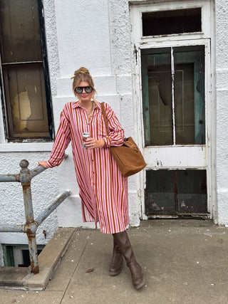 Woman wearing pink and rust striped button down maxi dress