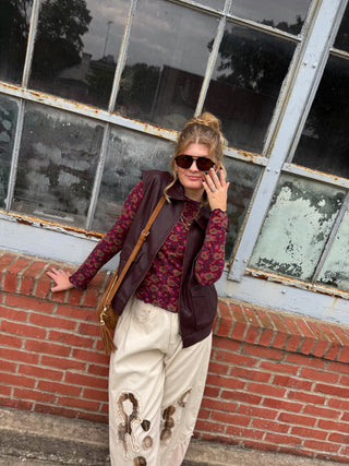 Woman wearing berry floral long sleeve tee