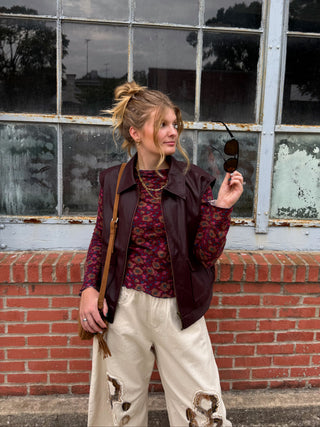 Woman wearing wine matte faux leather bomber vest