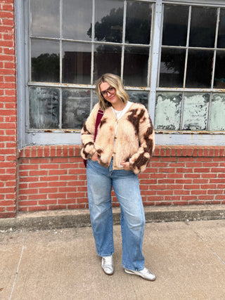 Woman wearing brown patterned fuzzy cardigan