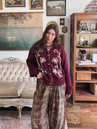 Woman wearing burgundy floral embroidered cardigan