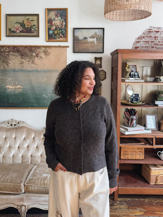 Woman wearing ash brown cable knit cardigan
