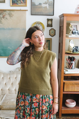 Woman wearing olive ribbed knit sweater vest