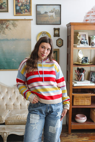 Woman wearing red multi striped knit hoodie
