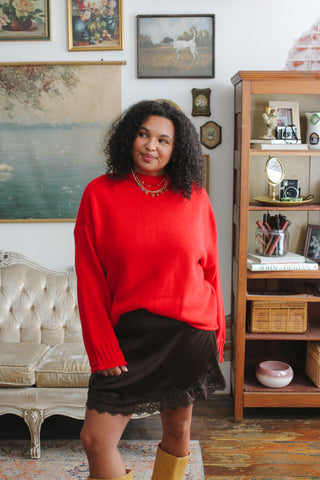 Woman wearing cherry mock neck ribbed knit sweater
