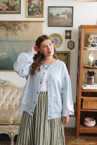 Woman wearing sky blue textured knit snap front cardigan