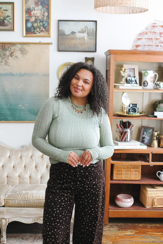 Woman wearing sage lace long sleeve layering top
