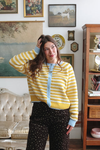 Woman wearing yellow striped knit cardigan