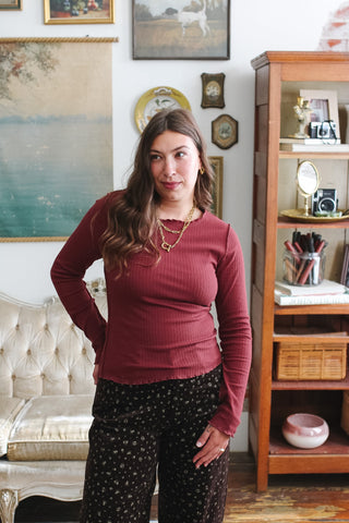 Woman wearing chocolate ribbed long sleeve top
