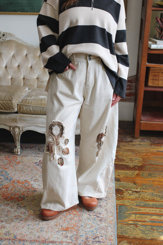 Woman wearing ivory patchwork wide barrel jeans