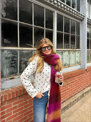 Woman wearing the Campbell white polka dot knit pullover sweater with black dots and wide leg jeans