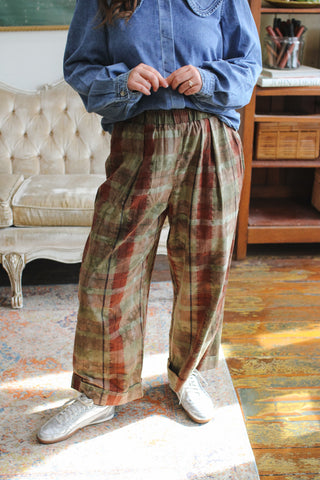 Woman wearing olive plaid pull-on pants