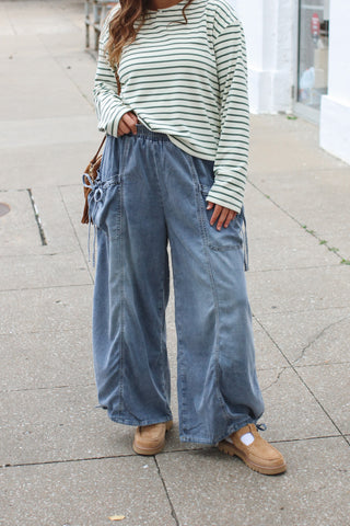 Woman wearing light wash denim tie pocket pants