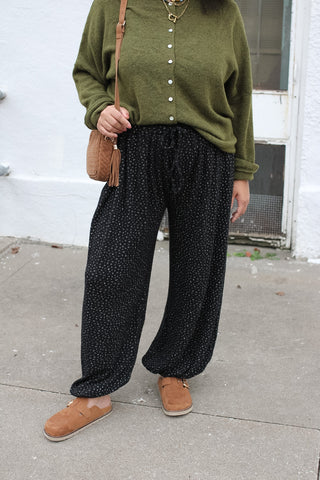 Woman wearing black micro floral ribbed knit joggers