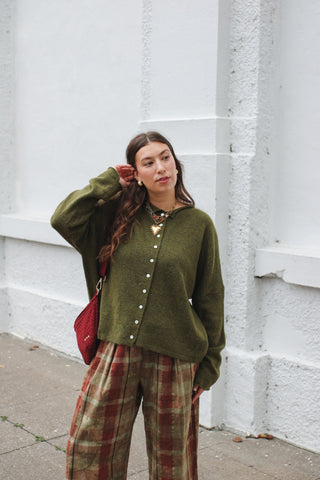 Woman wearing heathered olive knit cardigan