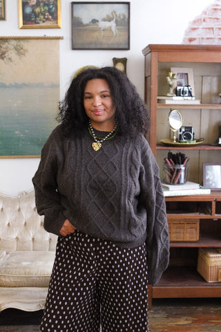 Woman wearing the Emme espresso cable knit pullover sweater with ribbed cuffs