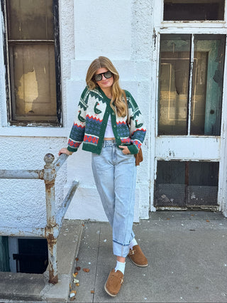 Woman wearing emerald duck print button front cardigan