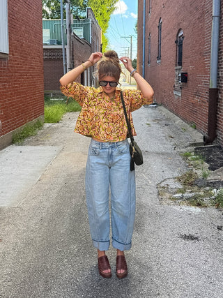 Woman wearing peach rose print cotton swing jacket