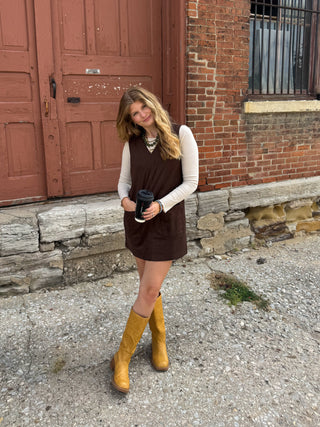 Woman wearing brown suede jumper dress