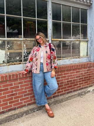 Woman wearing blush floral quilted velvet jacket