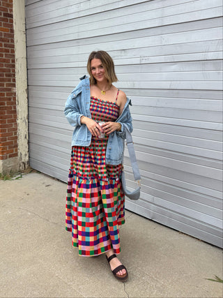 Woman wearing rainbow gingham smocked maxi dress