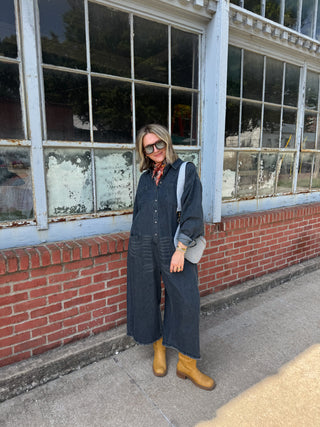 Woman wearing dark wash oversized denim jumpsuit