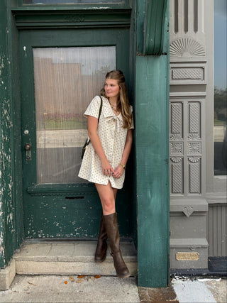 Woman wearing ivory polka dot corduroy mini dress