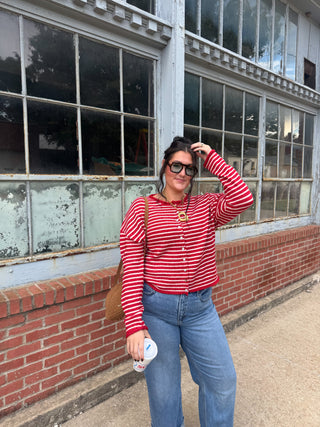 Woman wearing red striped button front cardigan