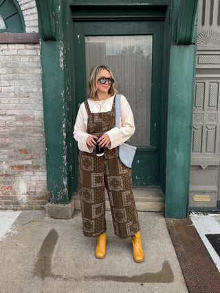 Woman wearing olive bandana print overalls