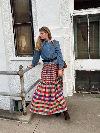 Woman wearing medium wash denim top with ruffle collar