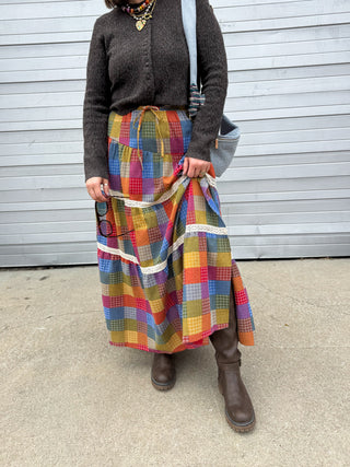 Woman wearing rainbow checked tiered maxi skirt