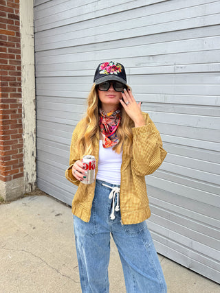 Woman wearing mustard yellow gingham bomber jacket