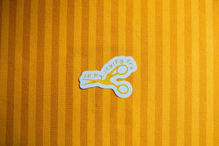 Sticker of a pair of scissors with in my sewing era text on it.