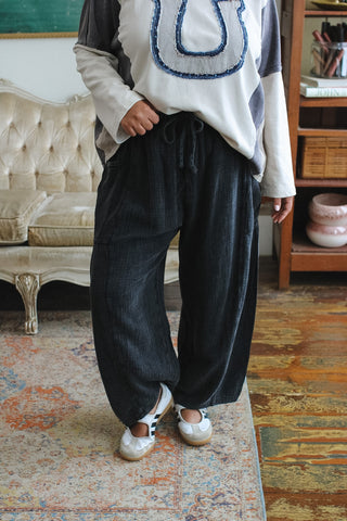 Woman wearing washed black gauze barrel leg pull-on pants