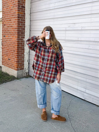 Woman wearing washed red oversized flannel button-up shirt