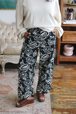 Woman wearing black and cream floral barrel leg pants