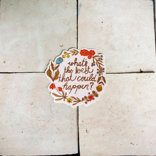A round white sticker with a floral border and the handwritten text 'what's the best that could happen?